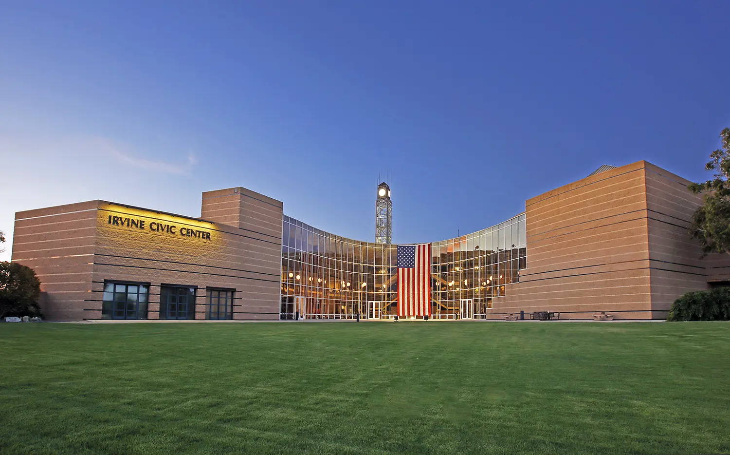 Irvine, California — Irvine City Hall building displays American flag.