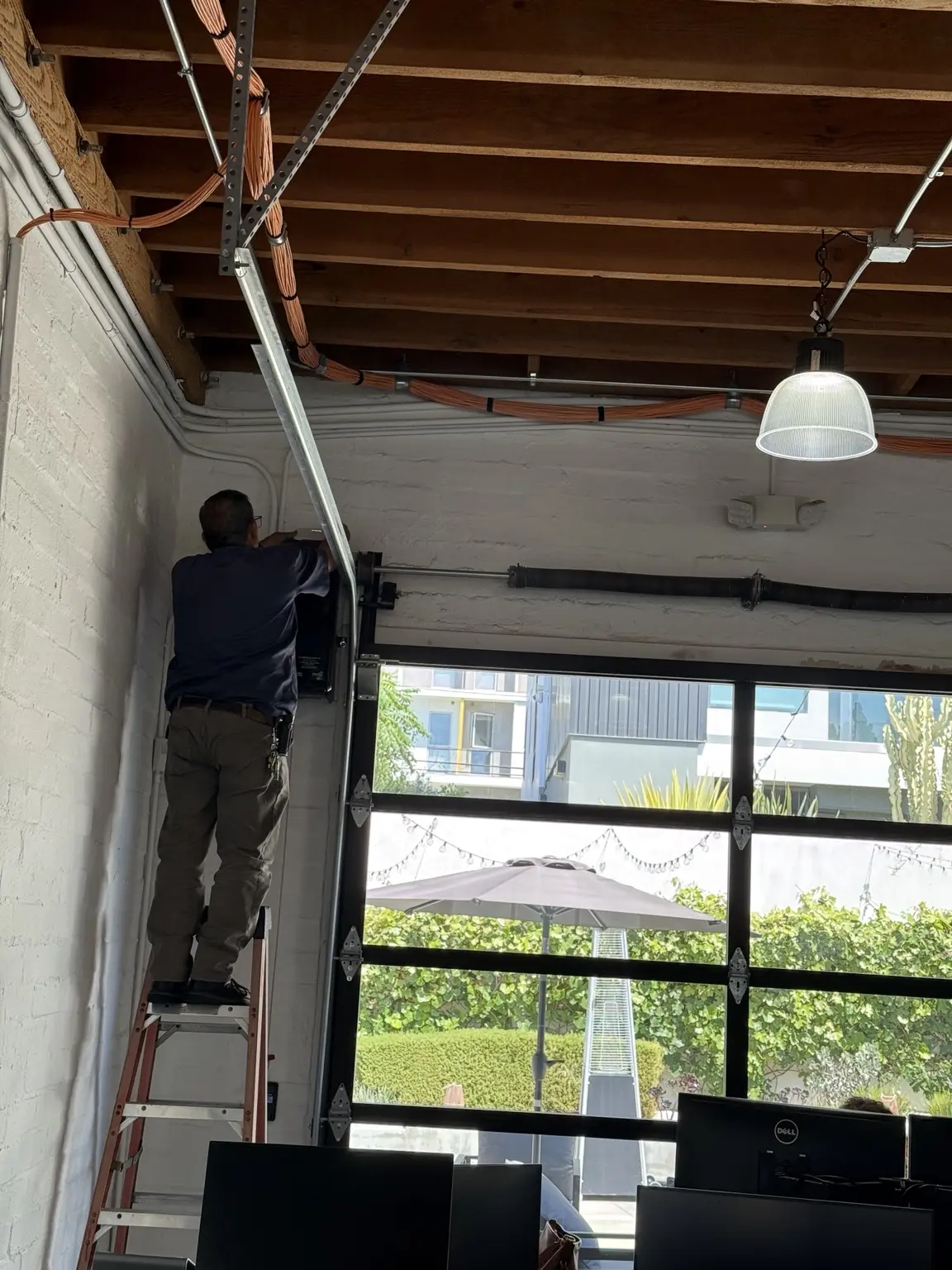 Three Factor Security technician servicing commercial alarm and security equipment infrastructure — Three Factor Security fieldwork in Downtown Los Angeles