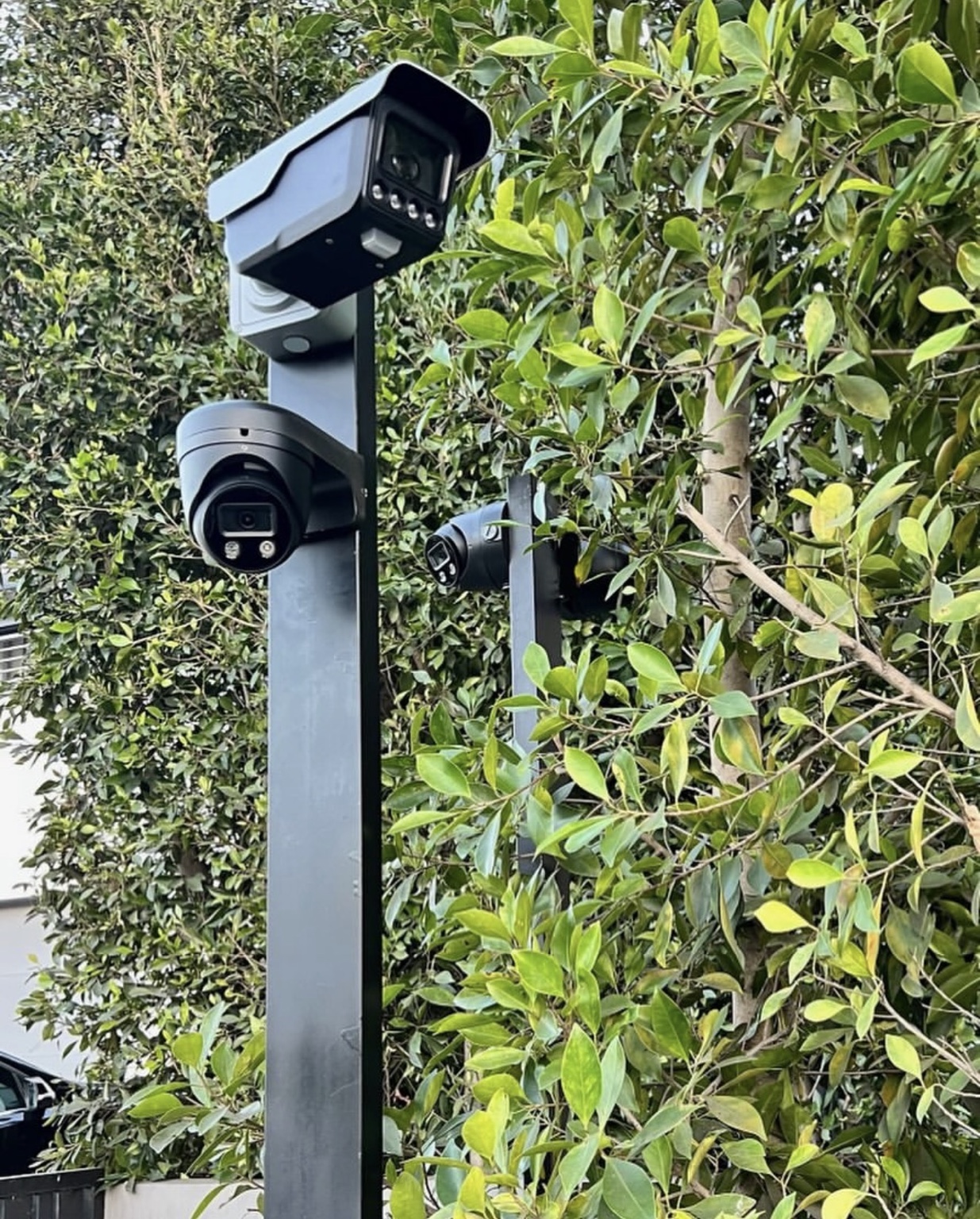 Custom multi-camera security post with fixed and dome cameras installed beside mature landscaping in West Hollywood — Three Factor Security fieldwork in West Hollywood
