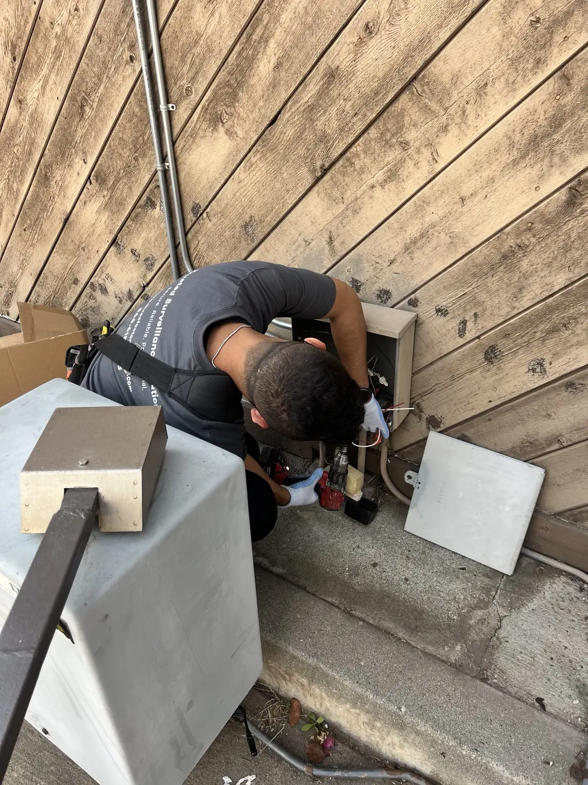 Three Factor Security technician servicing an exterior alarm panel — Three Factor Security fieldwork in Huntington Park