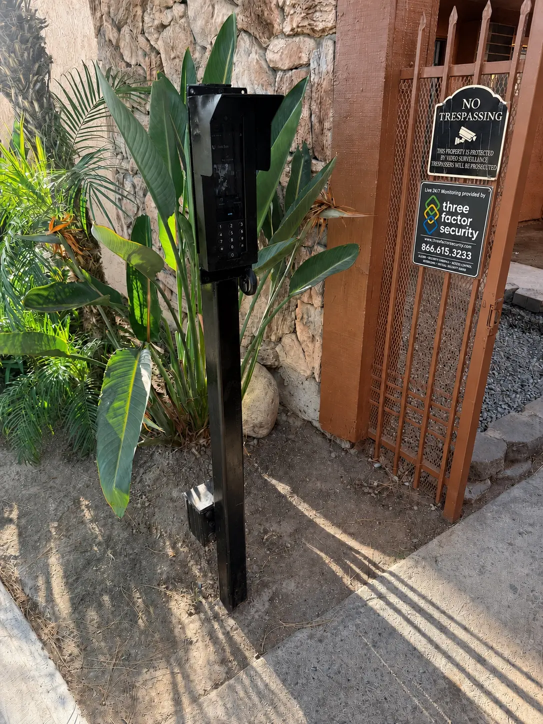Pedestrian gate video intercom installed beside a controlled walkway entrance — Three Factor Security fieldwork in Los Angeles