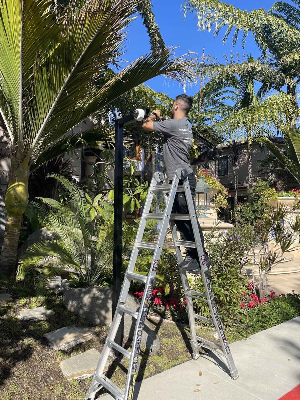 Early-detection camera installed in the landscaped perimeter of a residence — Three Factor Security fieldwork in Laguna Beach
