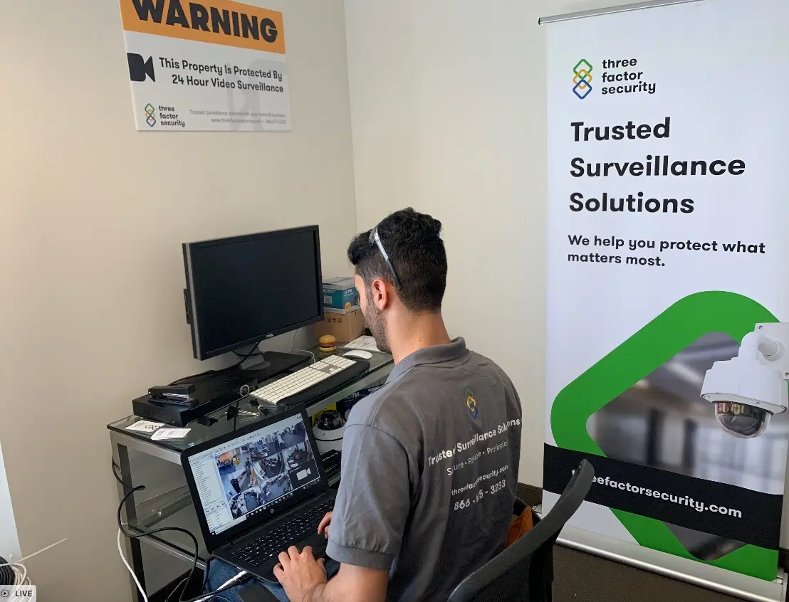 Three Factor Security technician configuring and verifying a professional surveillance system — Three Factor Security fieldwork in Downtown Los Angeles